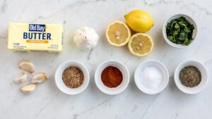 Seafood Boil Sauce Flat lay of all seafood boil sauce ingredients on a white marble table, bright overhead food photography,