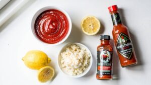 All cocktail sauce ingredients gathered and laid out on a white table ready to prepare.