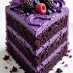Purple velvet cake recipe with glossy frosting and berry topping