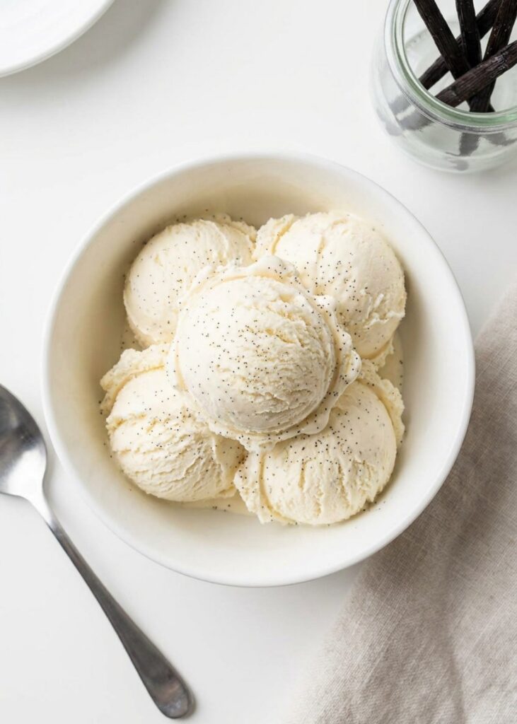Homemade Vanilla Ice Cream Overhead shot of homemade vanilla ice cream in a white bowl.