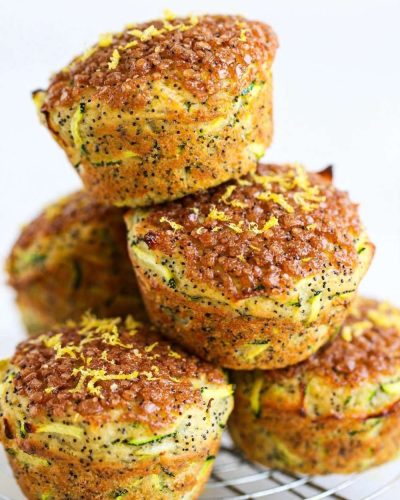 lemon poppyseed zucchini muffins on a cooling rack