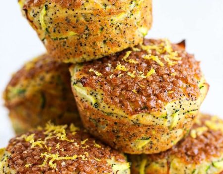 lemon poppyseed zucchini muffins on a cooling rack