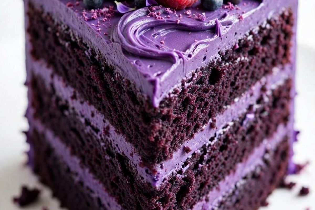 Purple velvet cake recipe with glossy frosting and berry topping