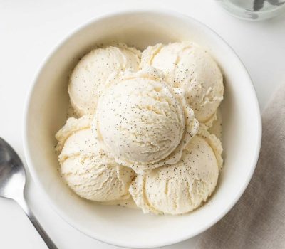 Overhead shot of homemade vanilla ice cream in a white bowl.