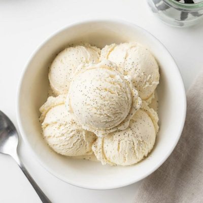 Overhead shot of homemade vanilla ice cream in a white bowl.