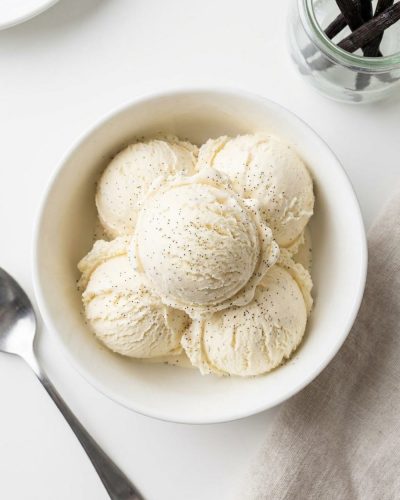 Overhead shot of homemade vanilla ice cream in a white bowl.