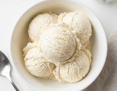 Overhead shot of homemade vanilla ice cream in a white bowl.