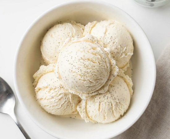 Overhead shot of homemade vanilla ice cream in a white bowl.