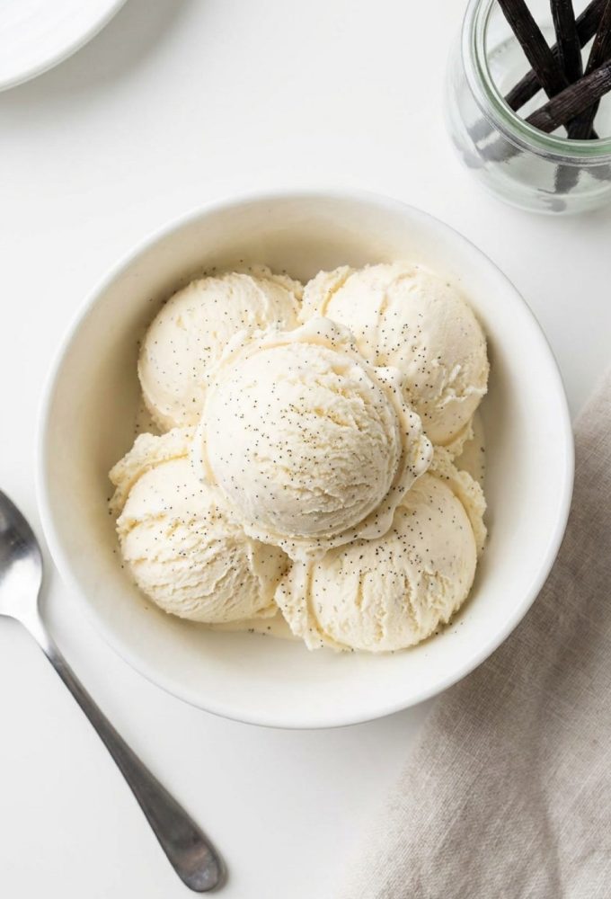 Overhead shot of homemade vanilla ice cream in a white bowl.