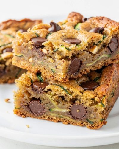 Almond butter chocolate chip zucchini bars arranged neatly on a white plate.