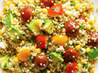 Vibrant avocado blueberry quinoa salad in a white bowl with toasted pepitas and fresh mint