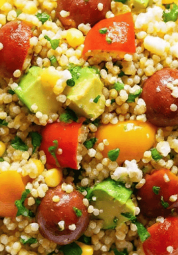 Vibrant avocado blueberry quinoa salad in a white bowl with toasted pepitas and fresh mint
