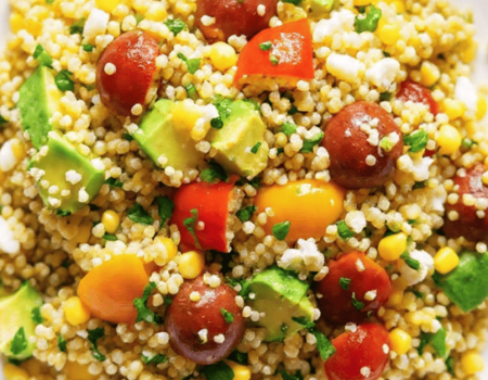 Vibrant avocado blueberry quinoa salad in a white bowl with toasted pepitas and fresh mint