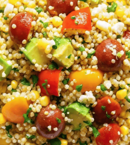 Vibrant avocado blueberry quinoa salad in a white bowl with toasted pepitas and fresh mint