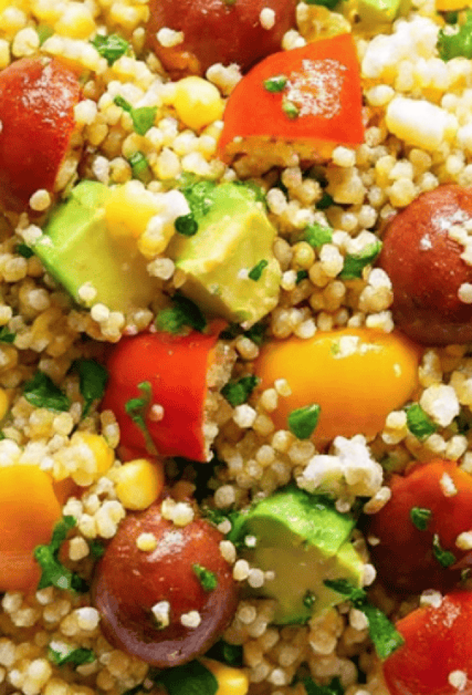 Vibrant avocado blueberry quinoa salad in a white bowl with toasted pepitas and fresh mint