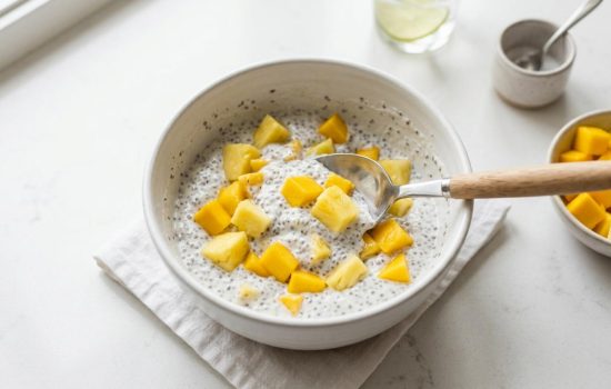 Folding mango and pineapple into chia pudding