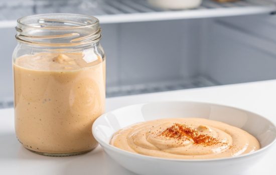 Step 5 — finished classic burger sauce in a white bowl garnished with paprika, ready to serve on a white marble table, horizontal food photography.