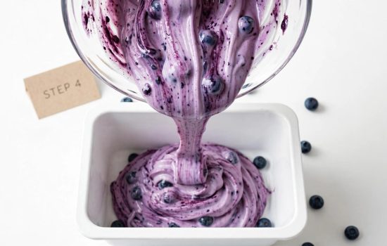 Pouring blueberry yogurt mixture into a freezer container.