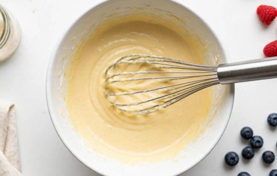 Whisking cupcake batter in a bowl