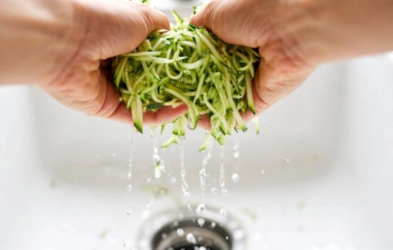 Squeezing excess water from grated zucchini