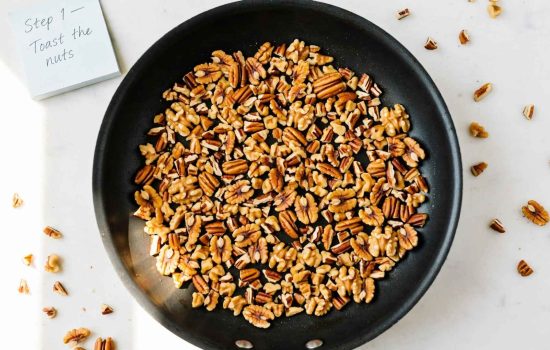 Toasting chopped pecans in a skillet