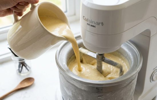 Pouring chilled vanilla custard base into an ice cream maker.
