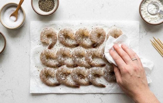 Seasoning raw shrimp with salt, pepper, and cornstarch, step 2