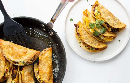 Egg roll tacos frying in golden hot oil in a non-stick skillet until crispy and golden brown.