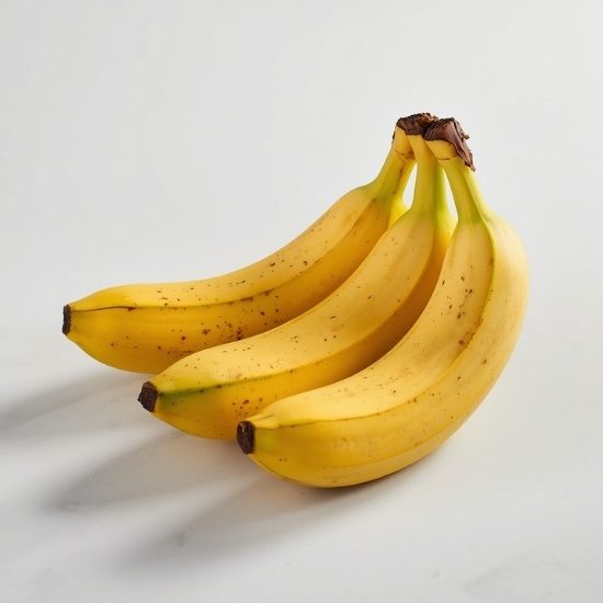 Ripe bananas on a white marble surface